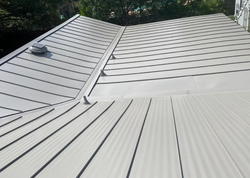 Solar attic fan installed on a metal roof for Roof Ventilation in Zachary
